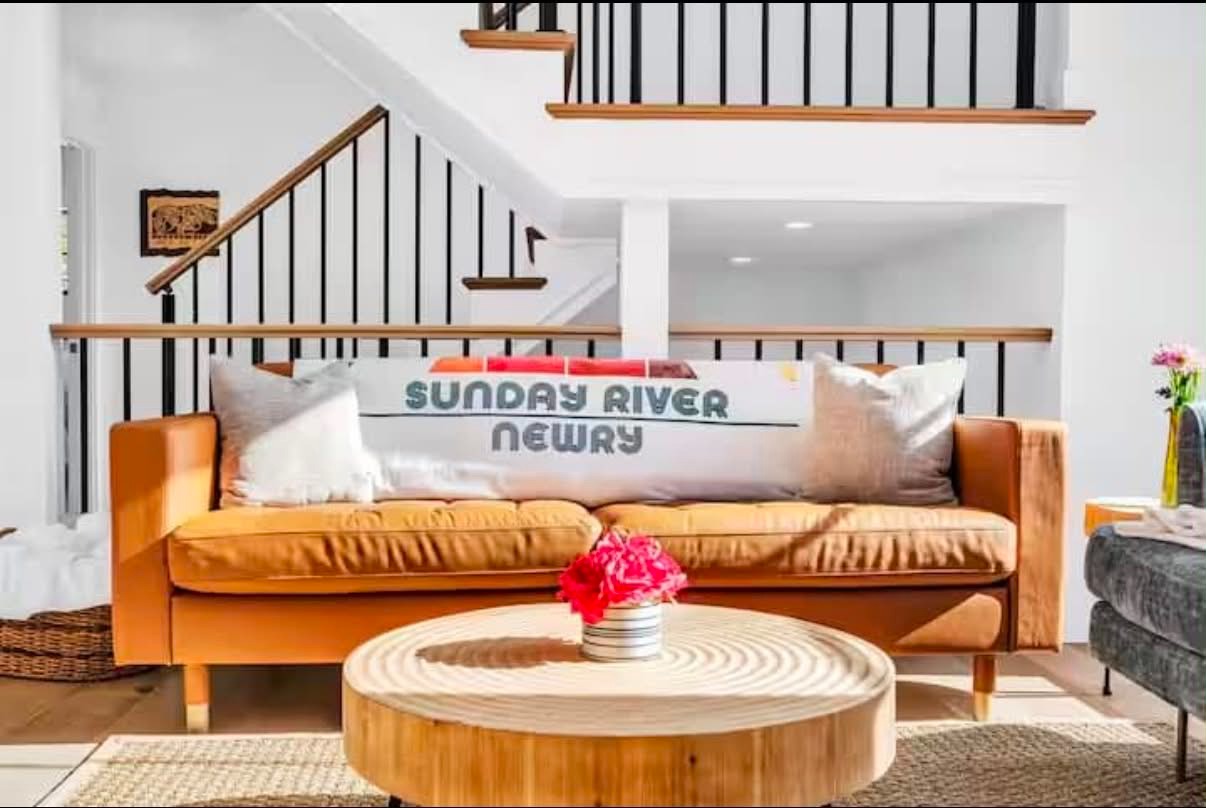 A warm, beautifully styled living room, freshly turned and ready for guests