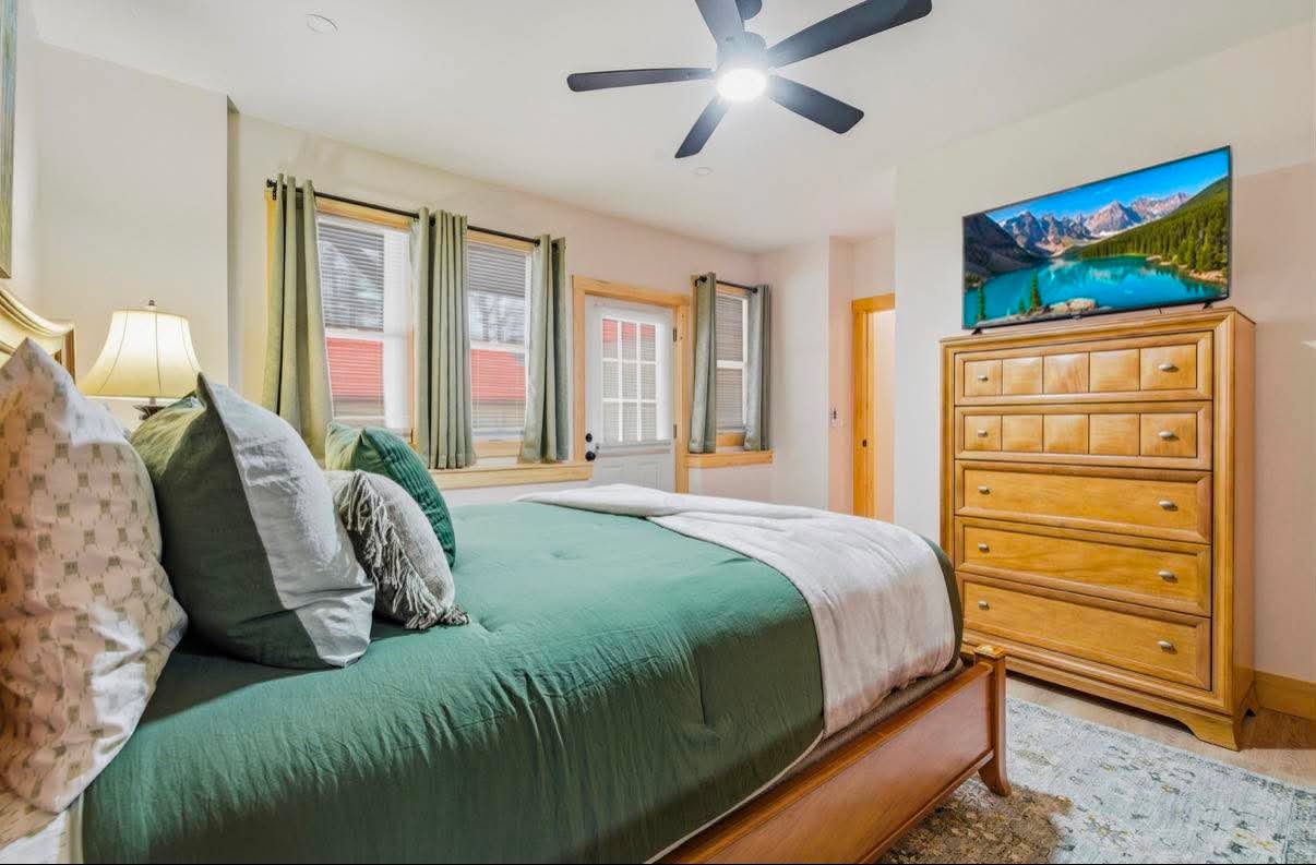 Green-and-gold guest room, freshly made