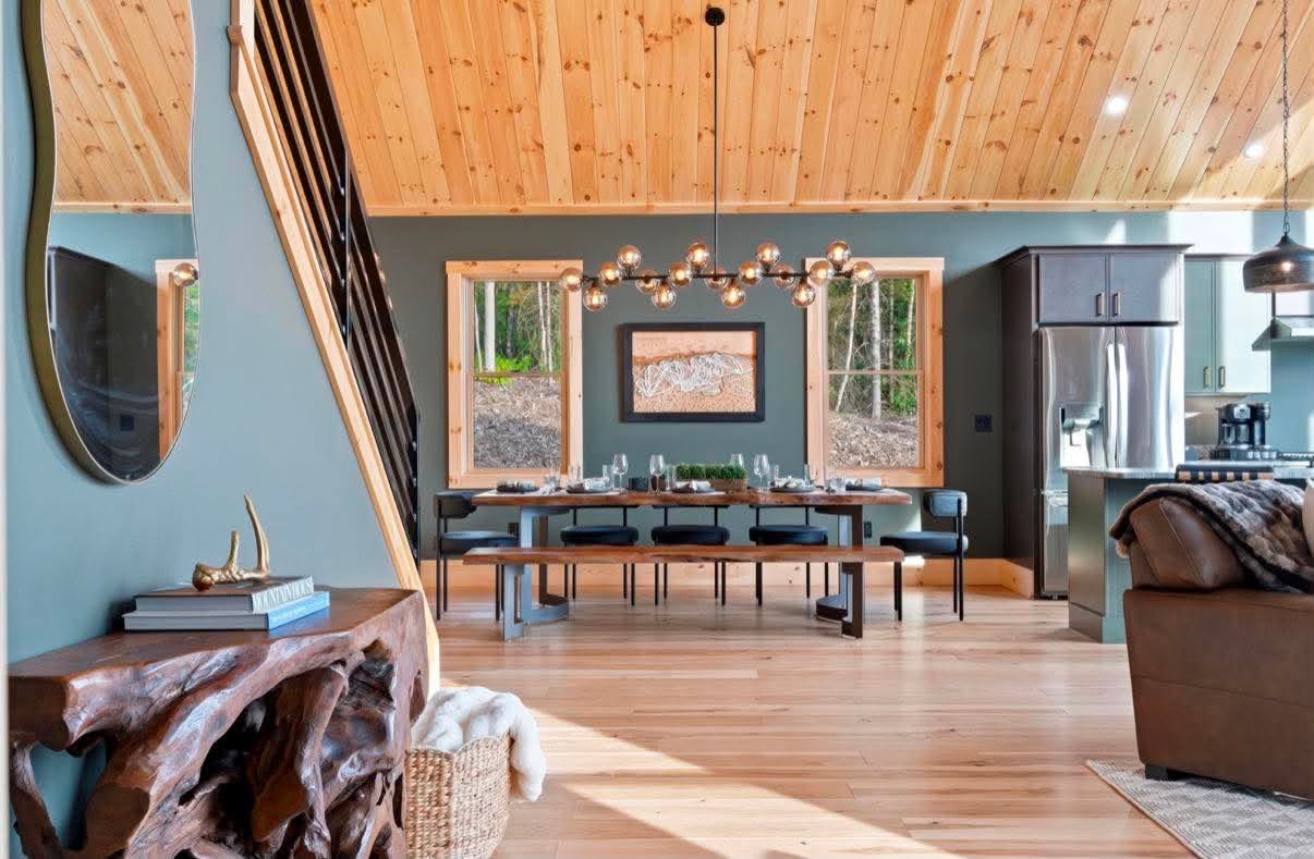 Live-edge dining under a modern chandelier